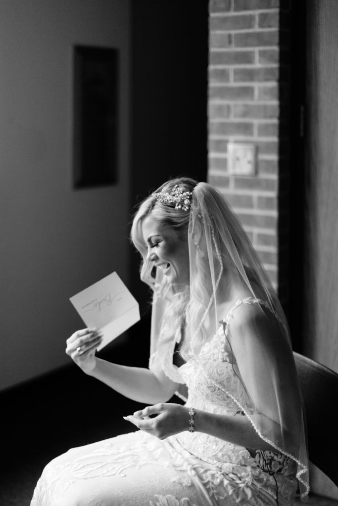 Bride cries and laughs as she reads letter from her groom.