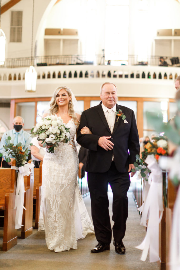 Bride coming down the aisle with her dad.