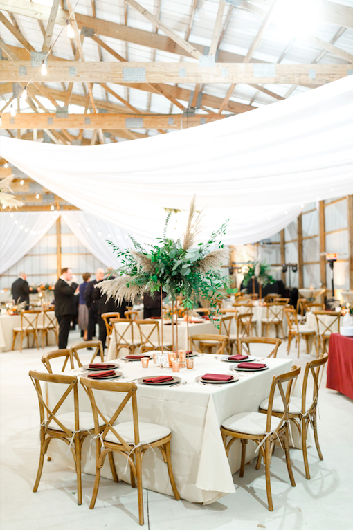 DIY wedding decor with burgundy accents and beautiful greenery. Wedding tablescape inspiration.